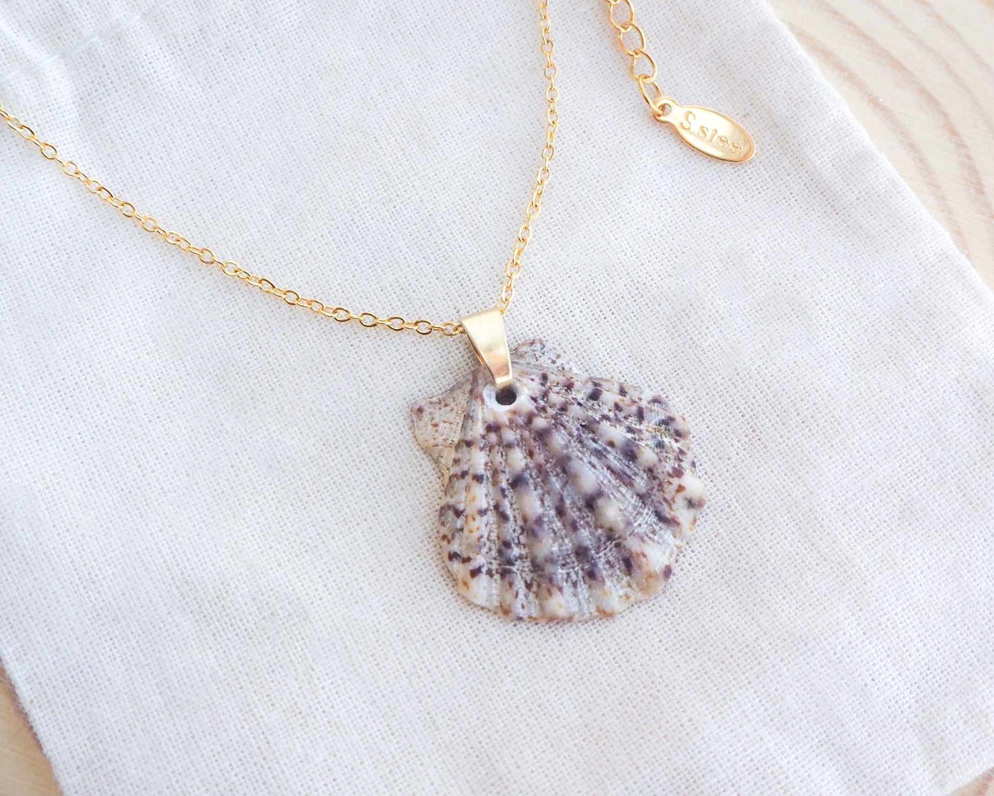 Gold Scallop Shell Necklace with Brown Leopard Scallop Shell on display