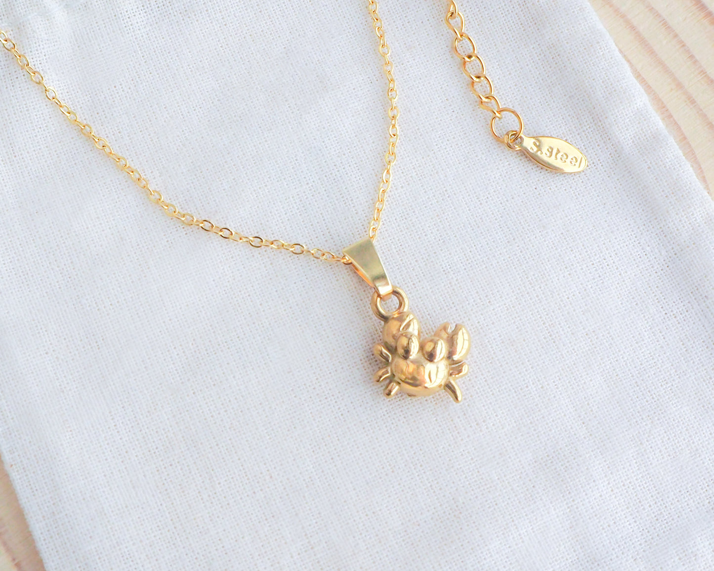 Gold Crab Necklace on display, Cancer Zodiac Sign Jewelry