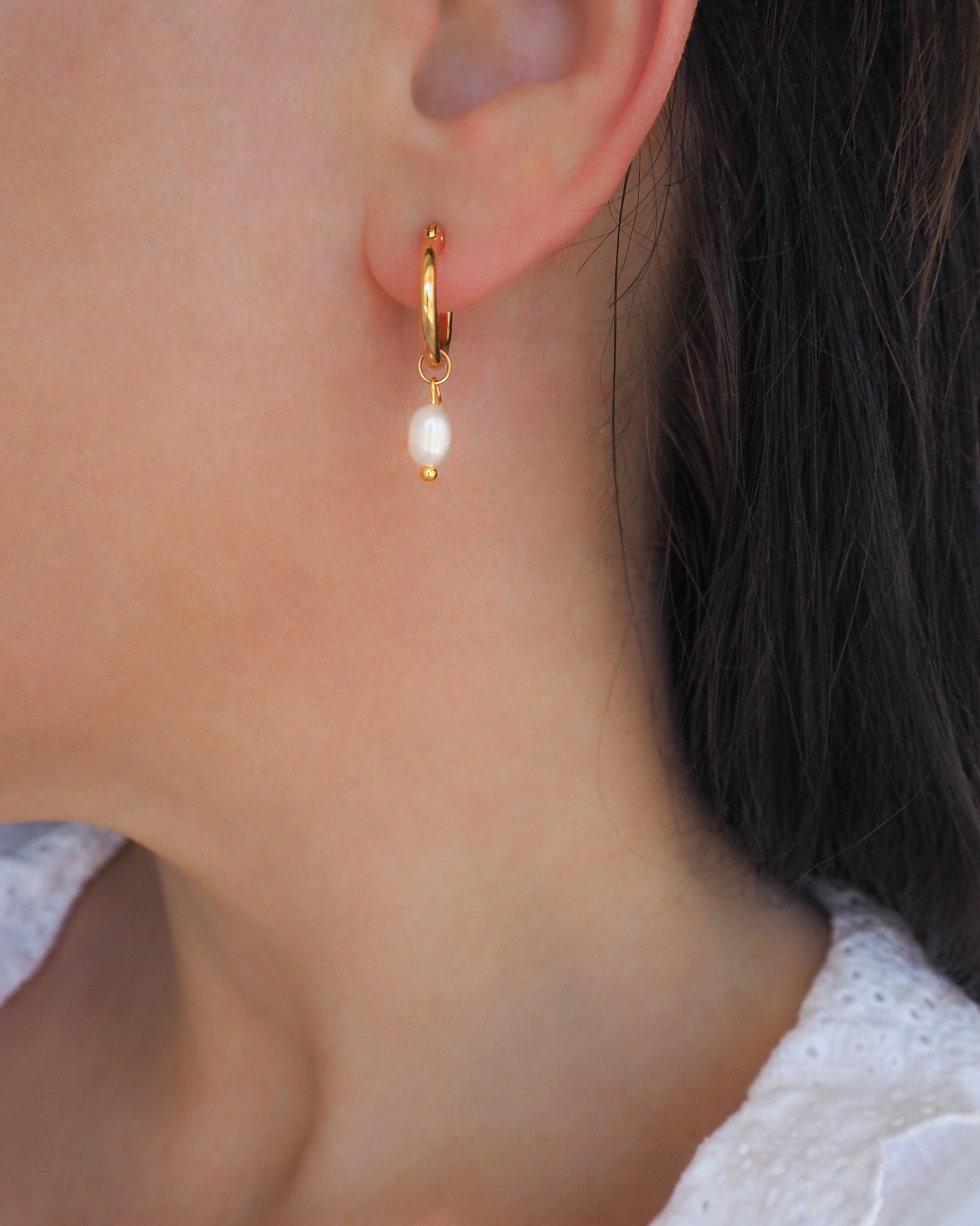 Gold Ivory White Pearl Earrings in ear model