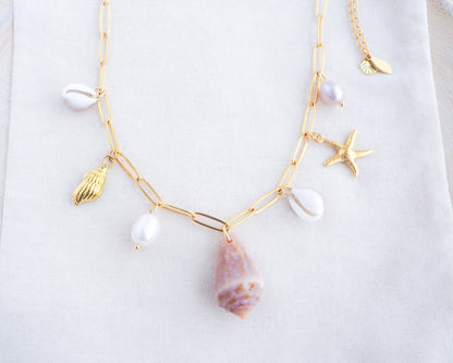 Gold Ocean Shell Charm Necklace detailed view, with cone and cowrie shells, freshwater pearls, starfish sea star shell pendants. 