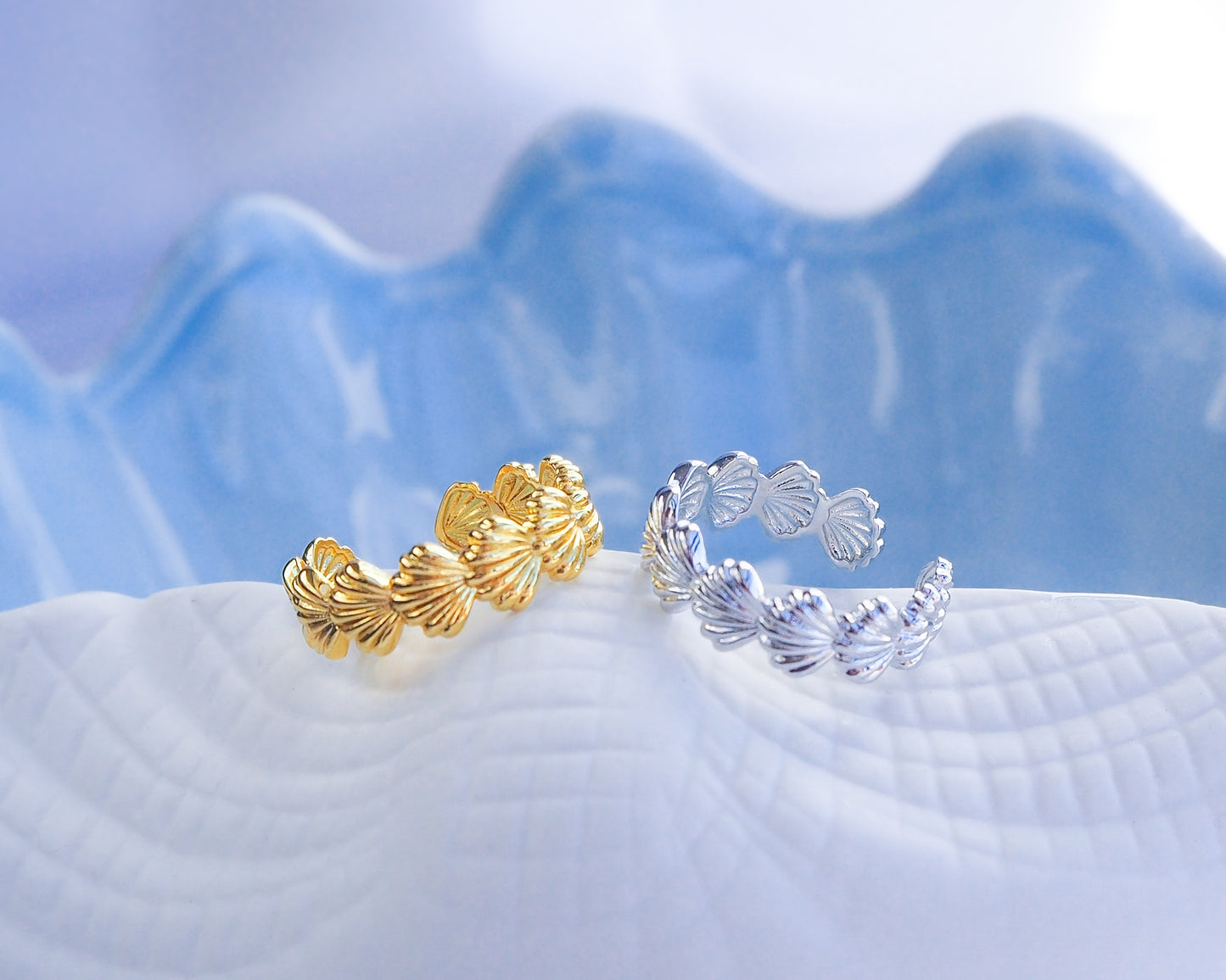 Gold and Silver Shell Rings on blue display, waterproof beach jewelry, adjustable rings