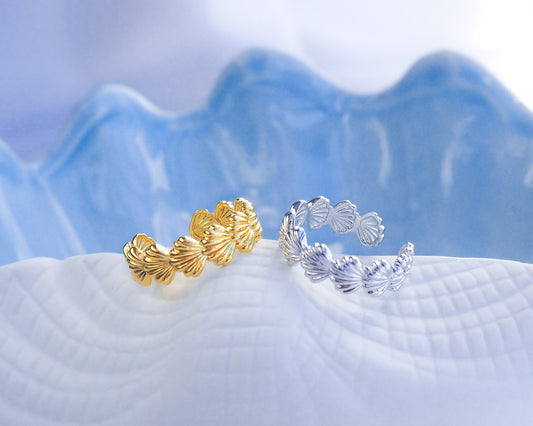 Gold and Silver Shell Rings on blue display, waterproof beach jewelry, adjustable rings