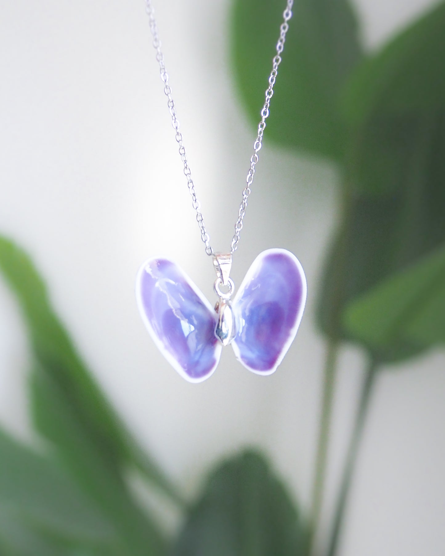 Purple Coquina Shell Butterfly Silver Necklace III front view with palm