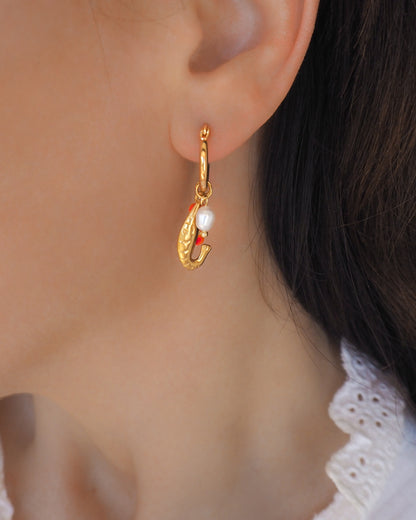 Model wearing Gold Shrimp Trio Earrings, Shrimp Huggies with freshwater pearls and coral red beads