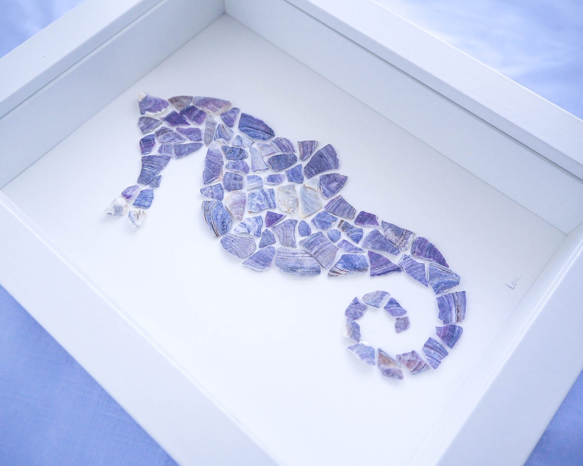 A detailed close-up of the seahorse mosaic, highlighting the meticulous arrangement of blue mussel shells that bring the creature's form to life