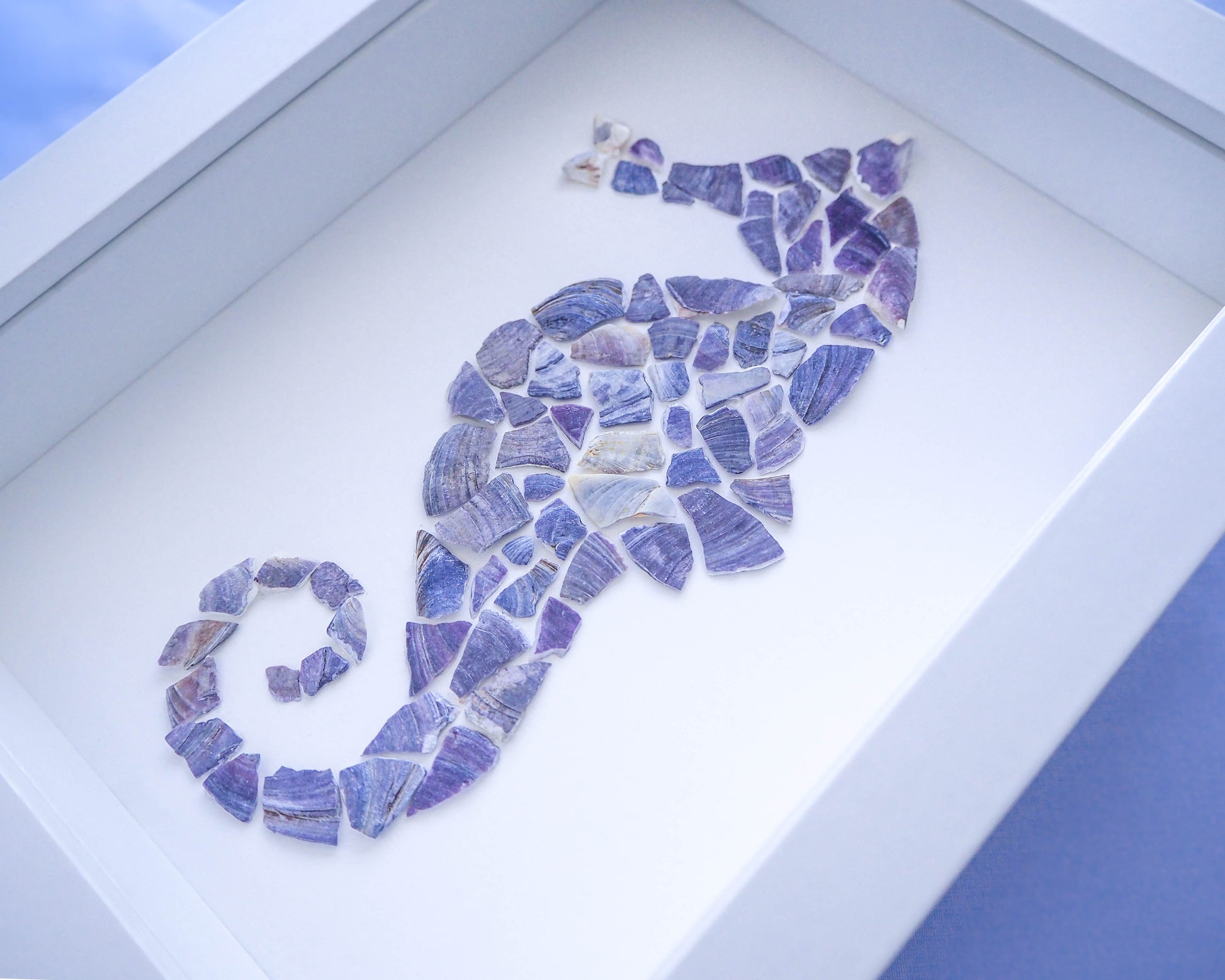 Close-up of the frame surrounding the seahorse mosaic, adding a rustic yet elegant touch that enhances the coastal charm of the artwork