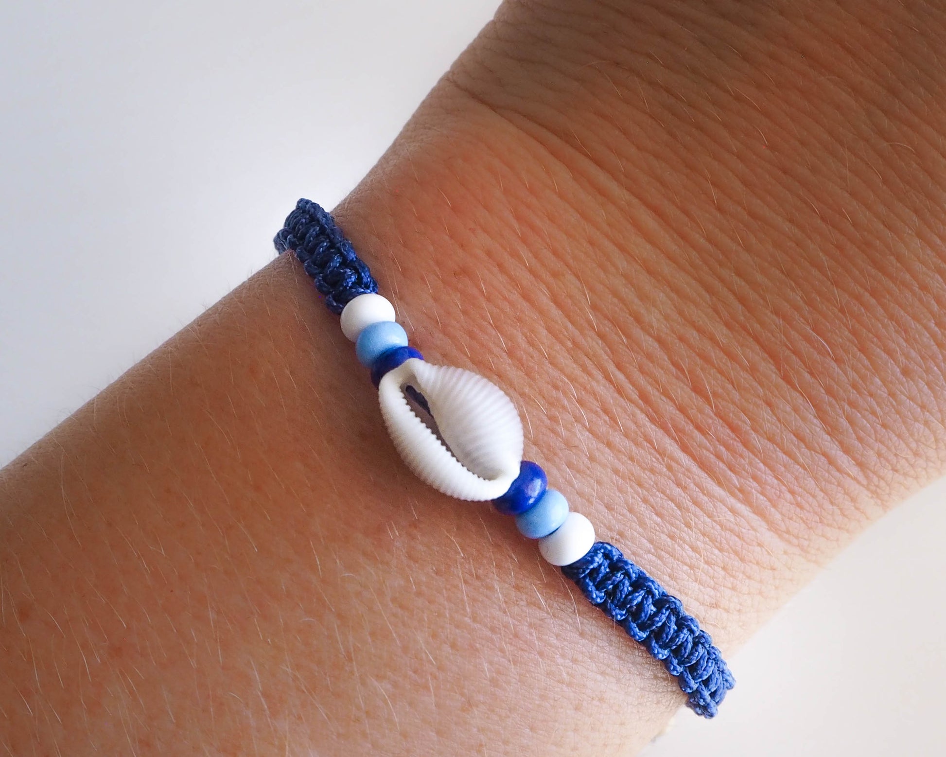 handmade cowrie sea shell bracelet Portugal, sea shell bracelet, seashell bracelet, seashell jewelry, cowrie shell bracelet, seabylou, sea by lou, blue braided bracelet, Cowrie Shell Bracelet, Trivia monacha 