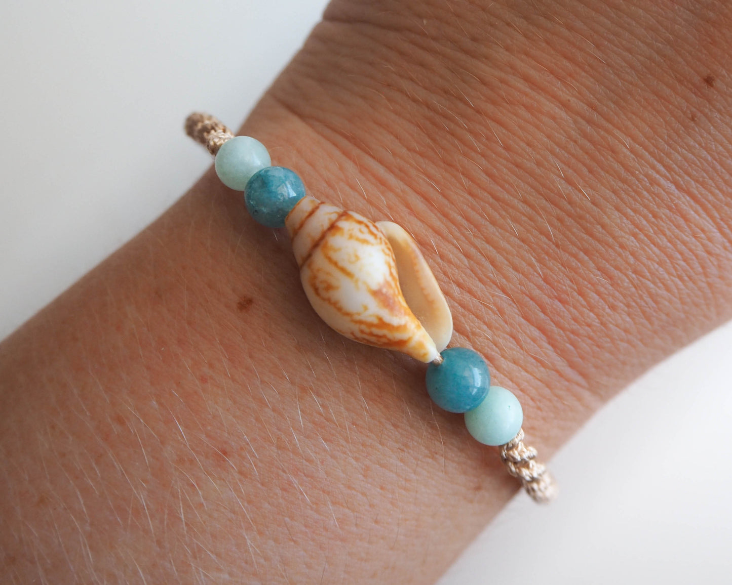 Handcrafted Beach-inspired Bracelet featuring Rustic Dove Shell, Gold Cord, and Jade Beads