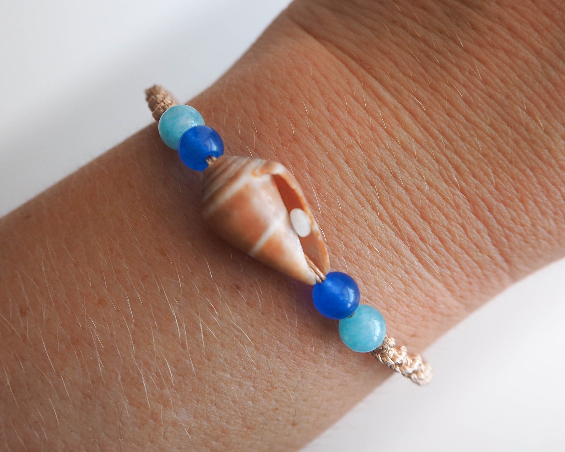 Unique Seashell and Gemstone Bracelet: Cone Shell, Gold Cord, and Aquamarine Beads