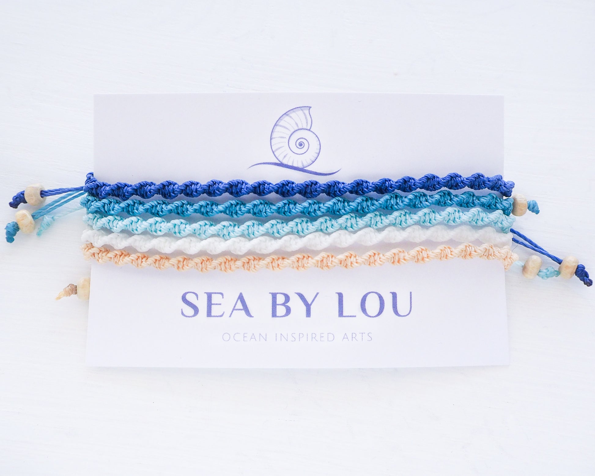 Ocean Lagoon colored braided bracelets on card