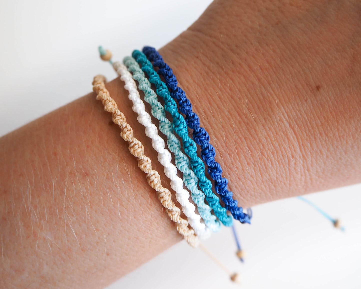 Ocean Lagoon colored braided bracelets on wrist