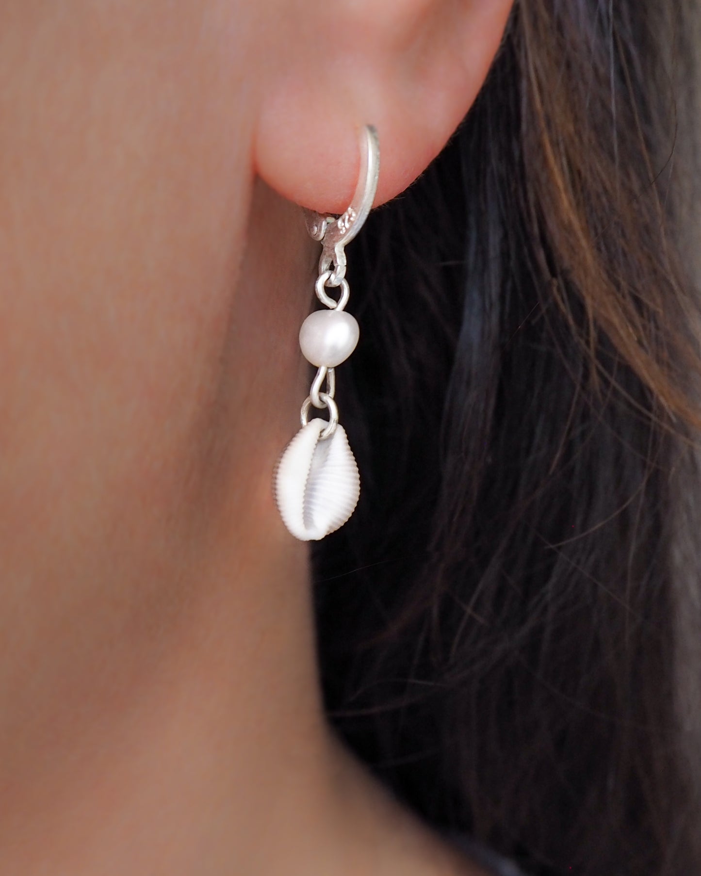 Model wearing Cowrie Shell Pearl Earrings from Portugal, Freshwater pearls with real Kauri shells