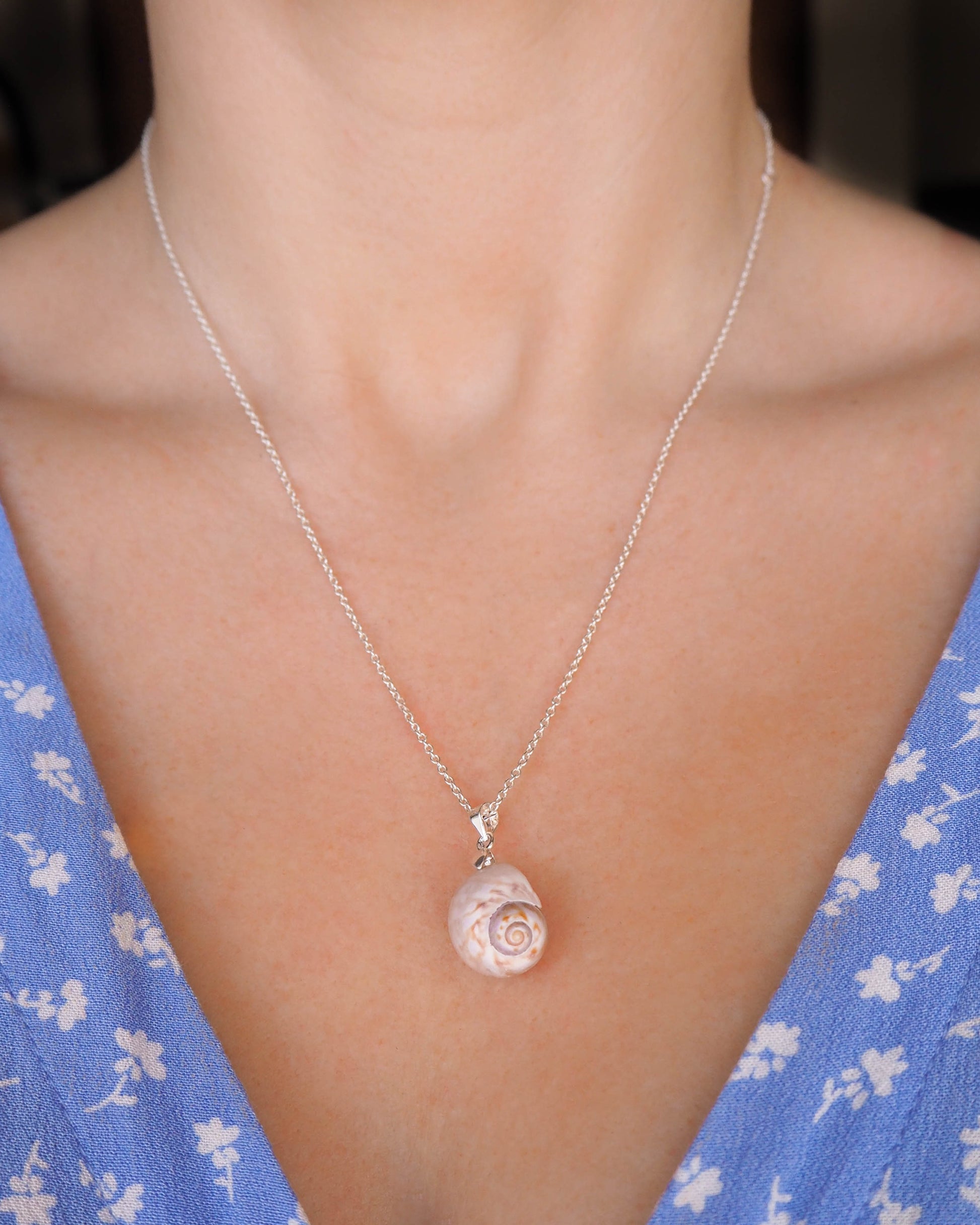 A model gracefully wearing the Moon Shell Silver Pendant, showcasing its coastal charm and elegance, Coastal Jewelry, Portuguese Inspiration, Nature-Inspired Pendant