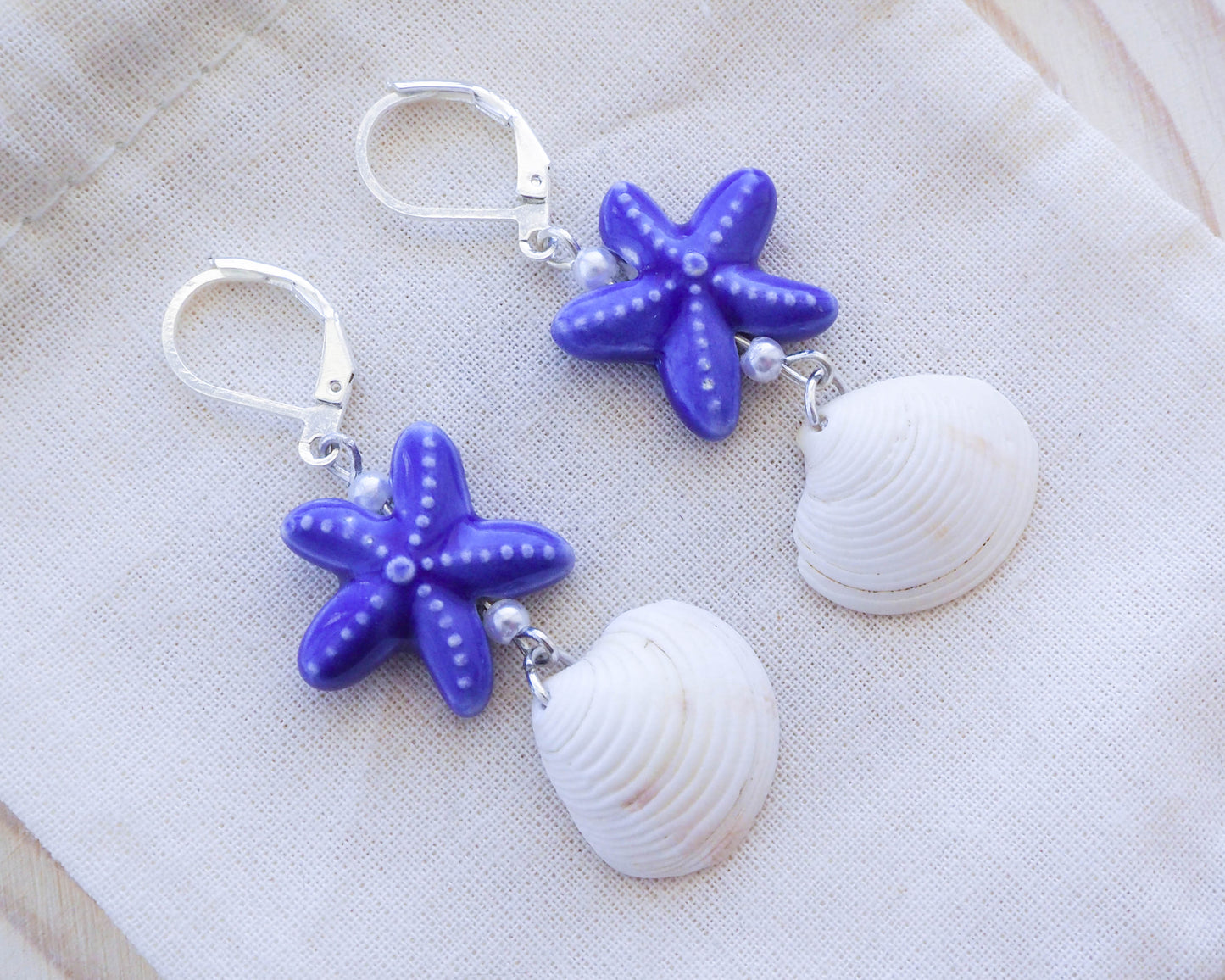 Ocean-Inspired Silver Earrings with Blue Ceramic Sea Stars and White Venus Shell