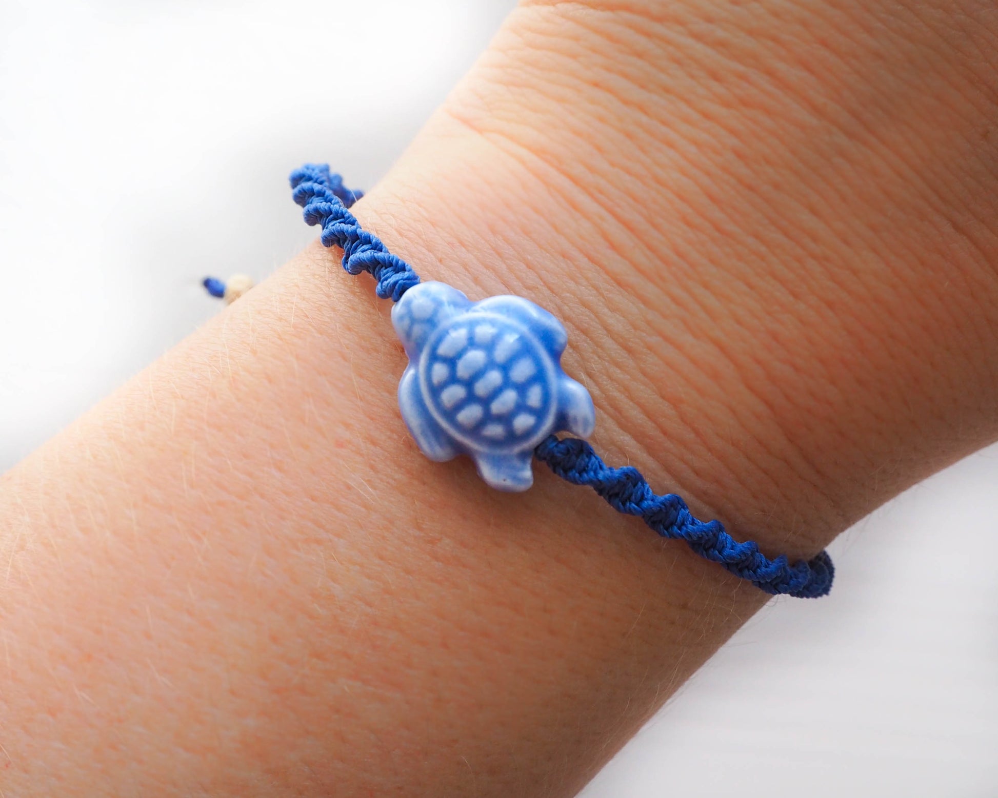 A high-resolution image showcasing the braided band of a Deep Blue Ceramic Turtle Braided Bracelet. The band is earthy and textured, creating a harmonious contrast with the ceramic turtle.