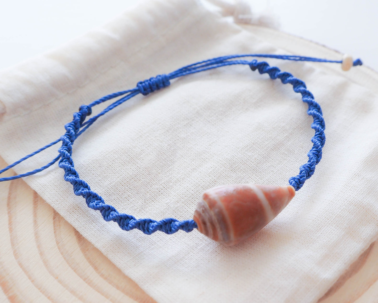 Close-up of Cone Shell on Dark Blue Braided Bracelet, Coastal Elegance, Seashell Jewelry, Beachcomber's Treasure, Portugal Cone Shell Bracelet