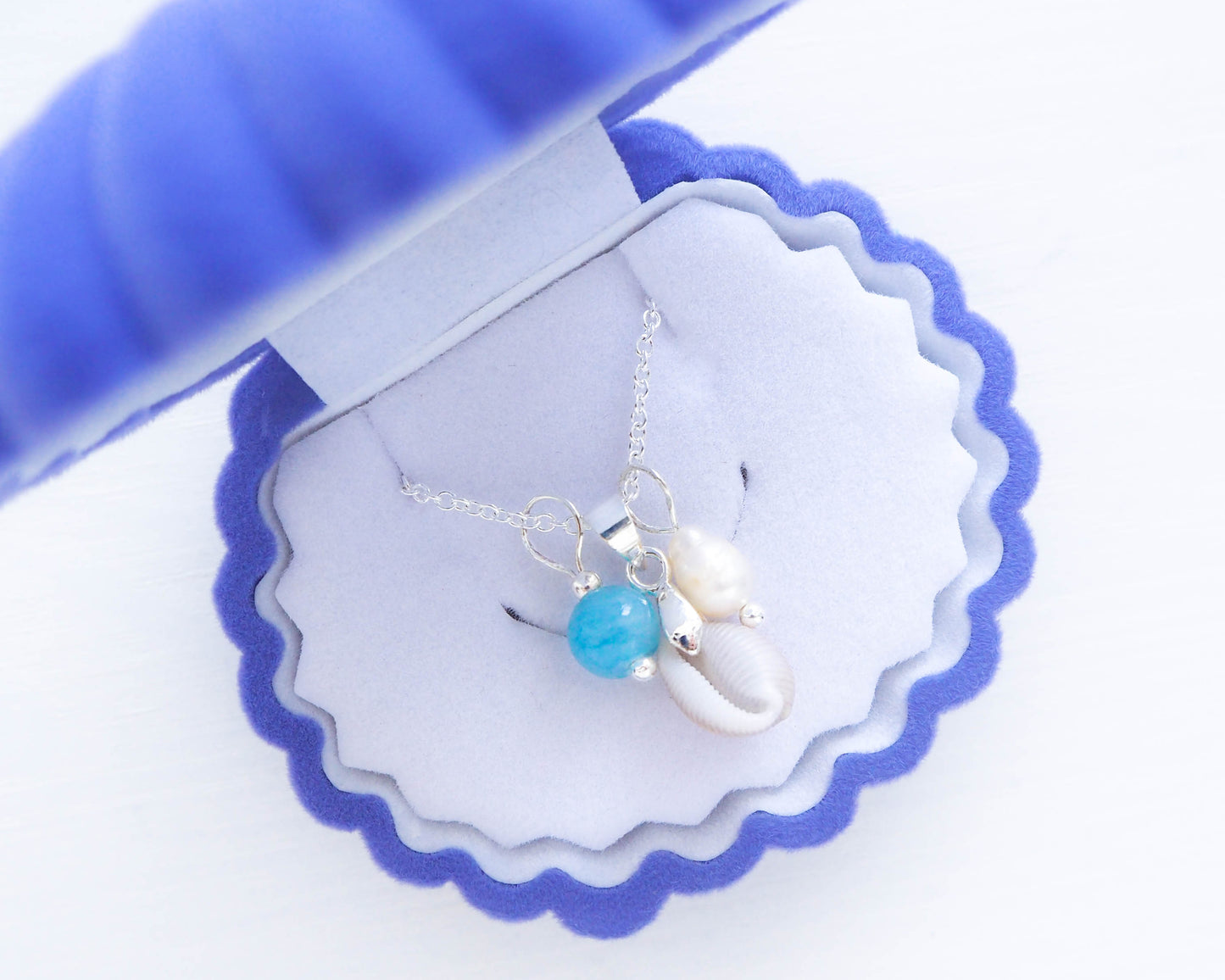 Ocean-Inspired Necklace Trio, easide Harmony Trio Necklace featuring Portuguese cowrie shell, aquamarine bead, and white freshwater pearl pendants on a 925 silver chain