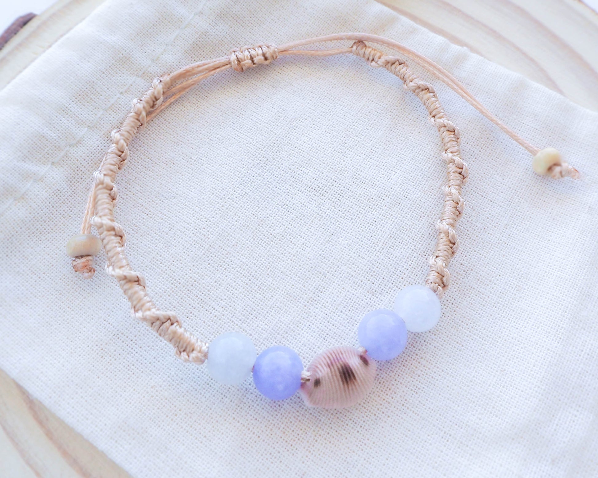 Angelite and Quartz Gemstone Beads Close-up with Cowrie shell bracelet from portugal 