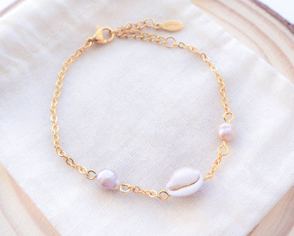 Close-up of Cowrie Shell and Freshwater Pearl Bracelet on Gold Chain