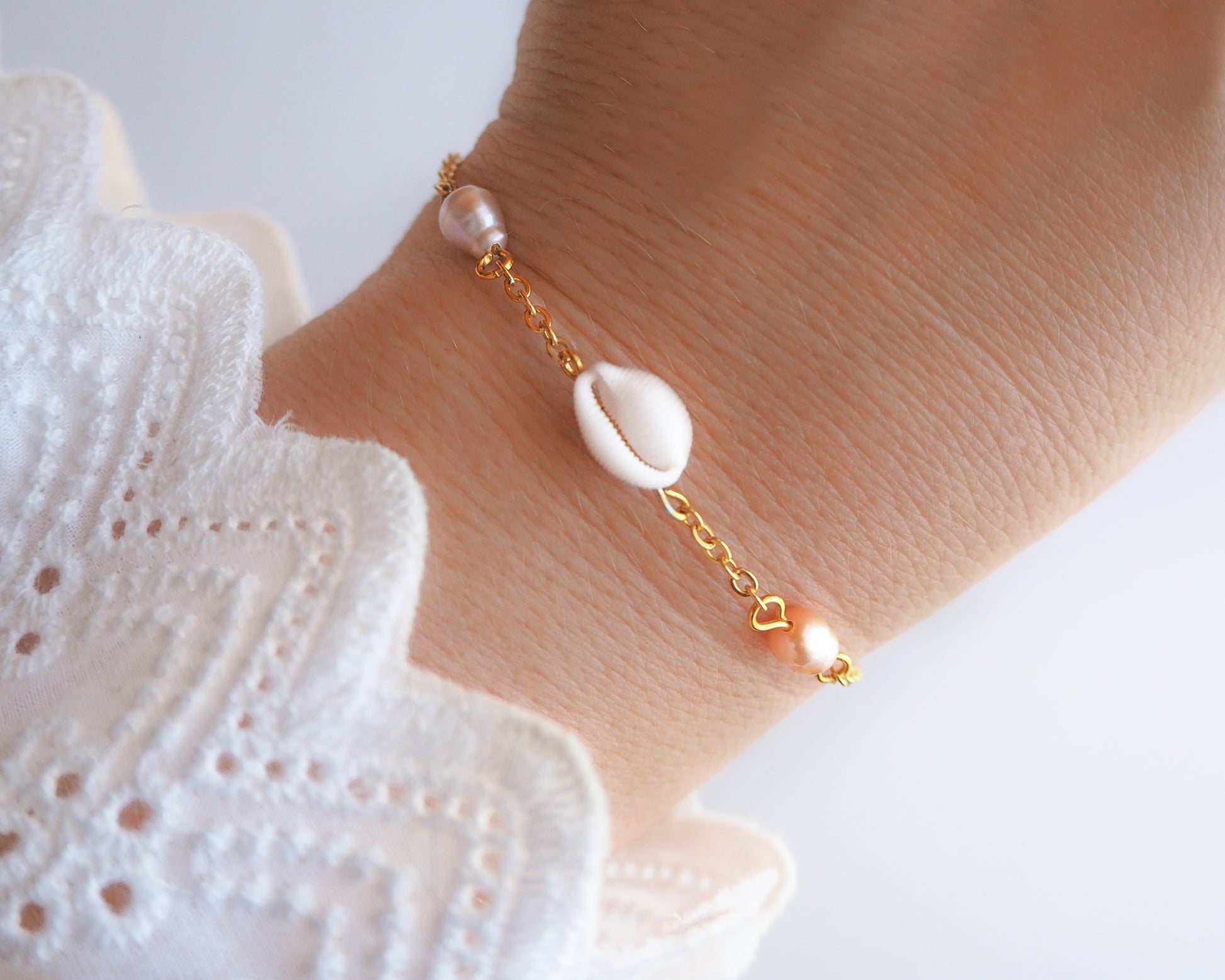Close-up of Cowrie Shell and Freshwater Pearl Bracelet on wrist