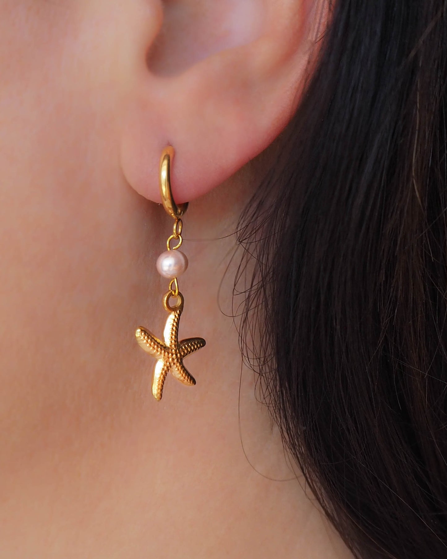 Model wearing gold Sea Star Stainless Steel Earrings with Freshwater pearl Beads and Golden Sea Star - Ocean Inspired Jewelry