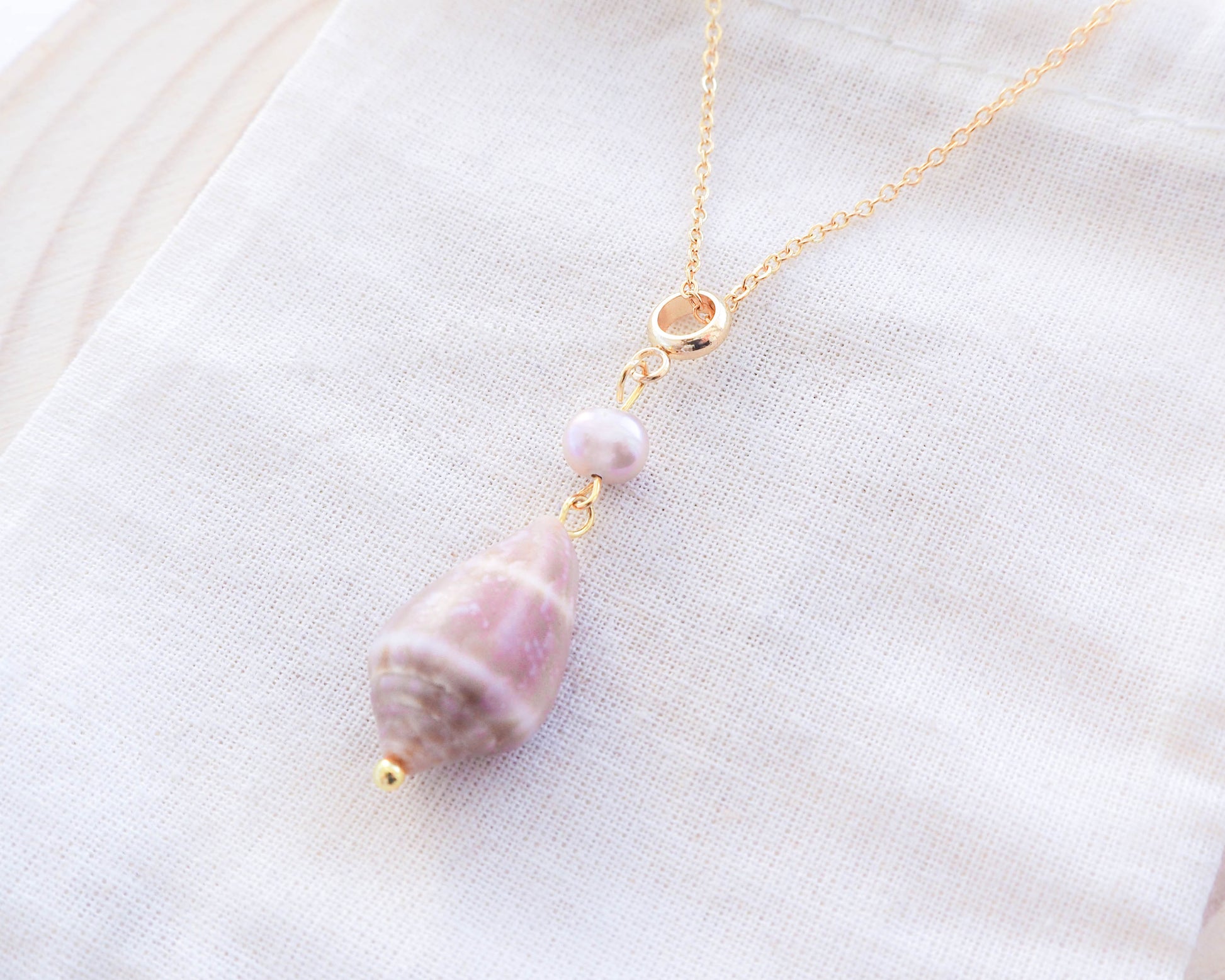 Close-up of Pendant: Freshwater Pearl and Cone Shell on Gold Stainless Steel Necklace