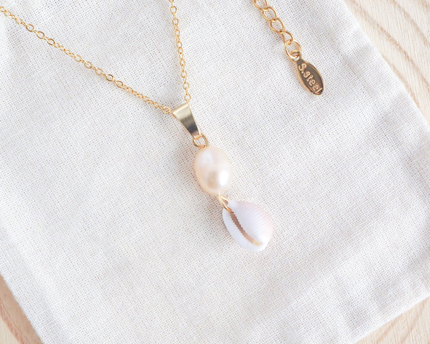 Gold Cowrie Shell Pearl Necklace, Champagne Freshwater Pearl on display