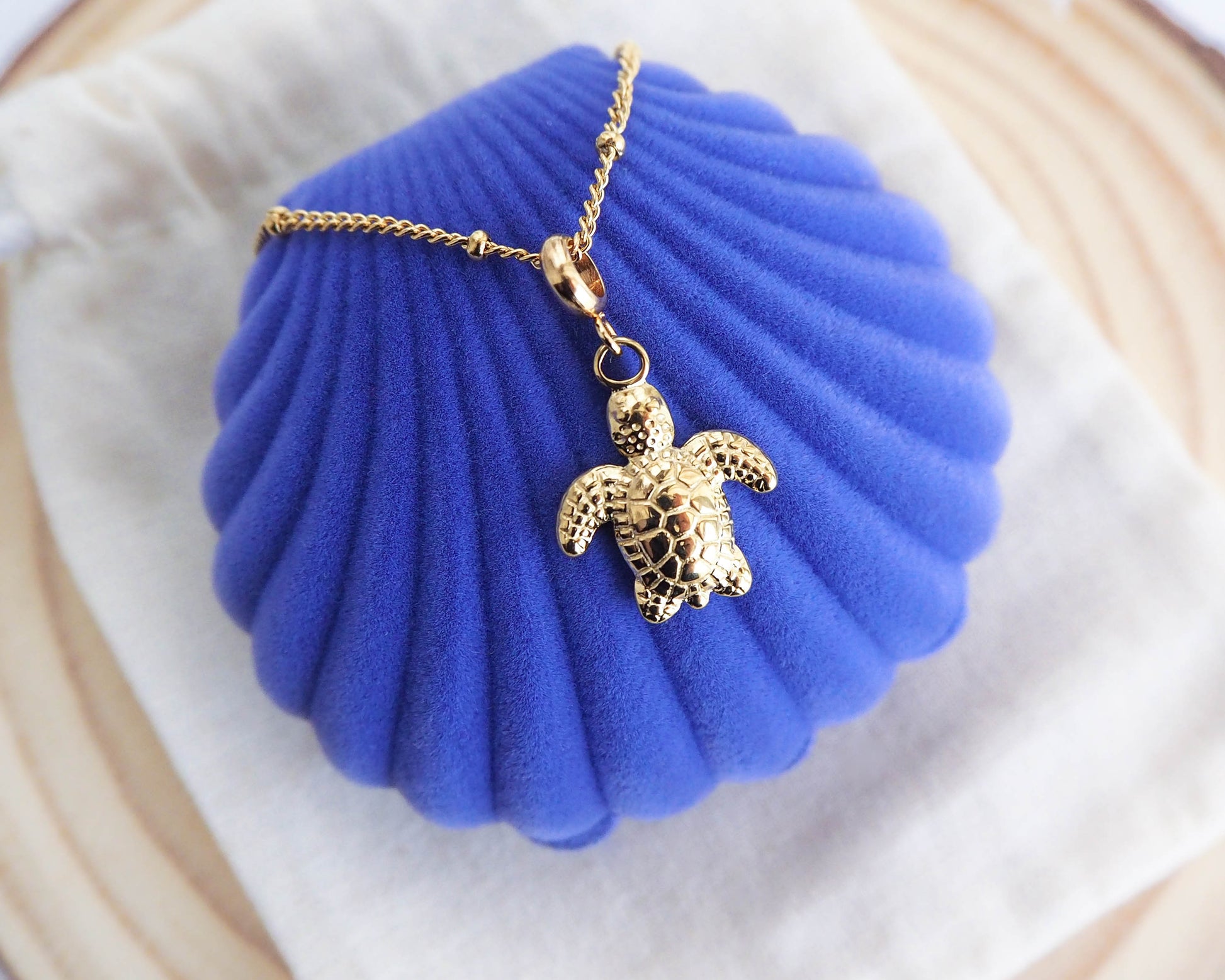Gold Turtle Necklace on Velvet Blue Shell Jewelry Box