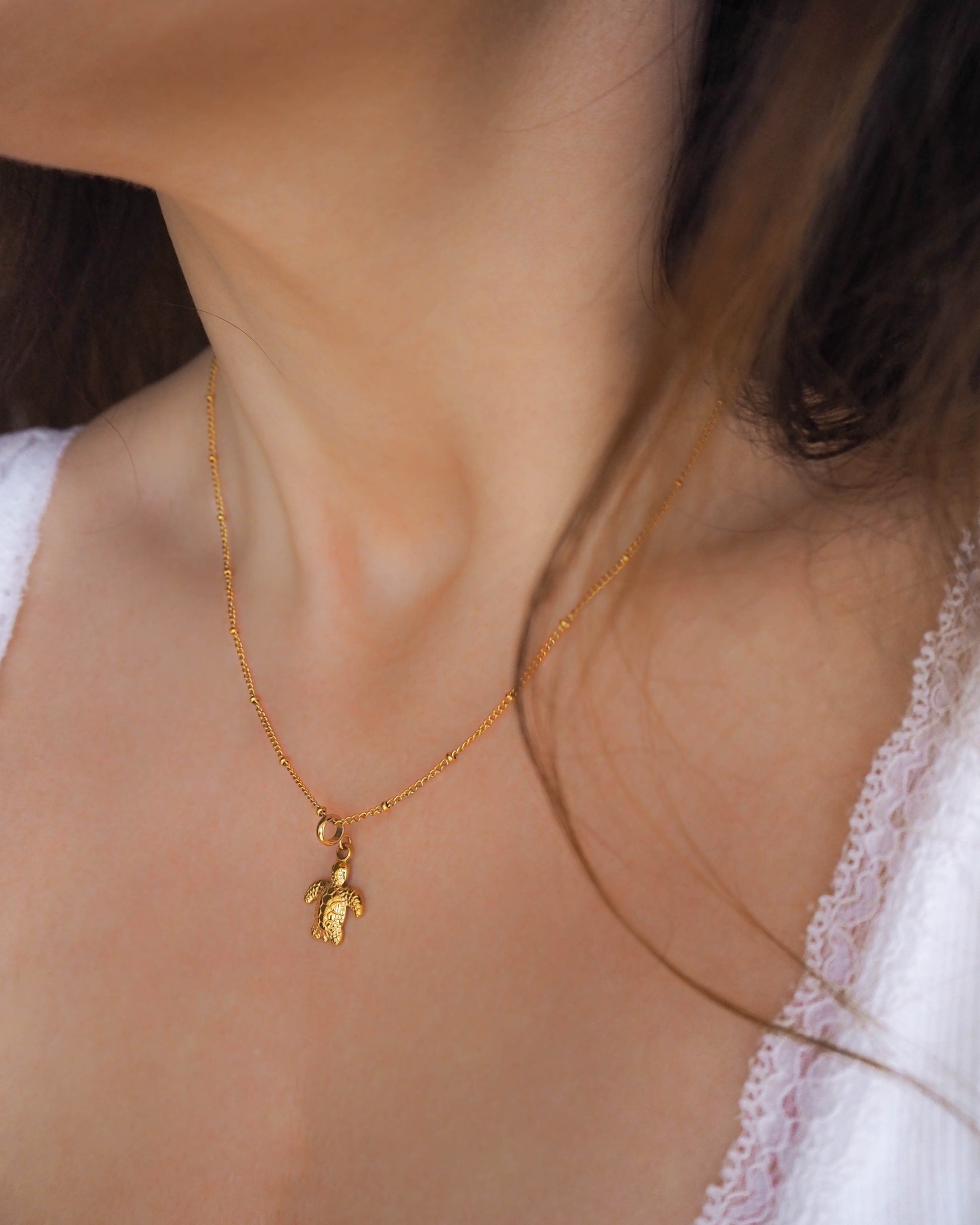 Model wearing Gold Turtle Necklace hypo allergen waterproof stainless steel jewelry 