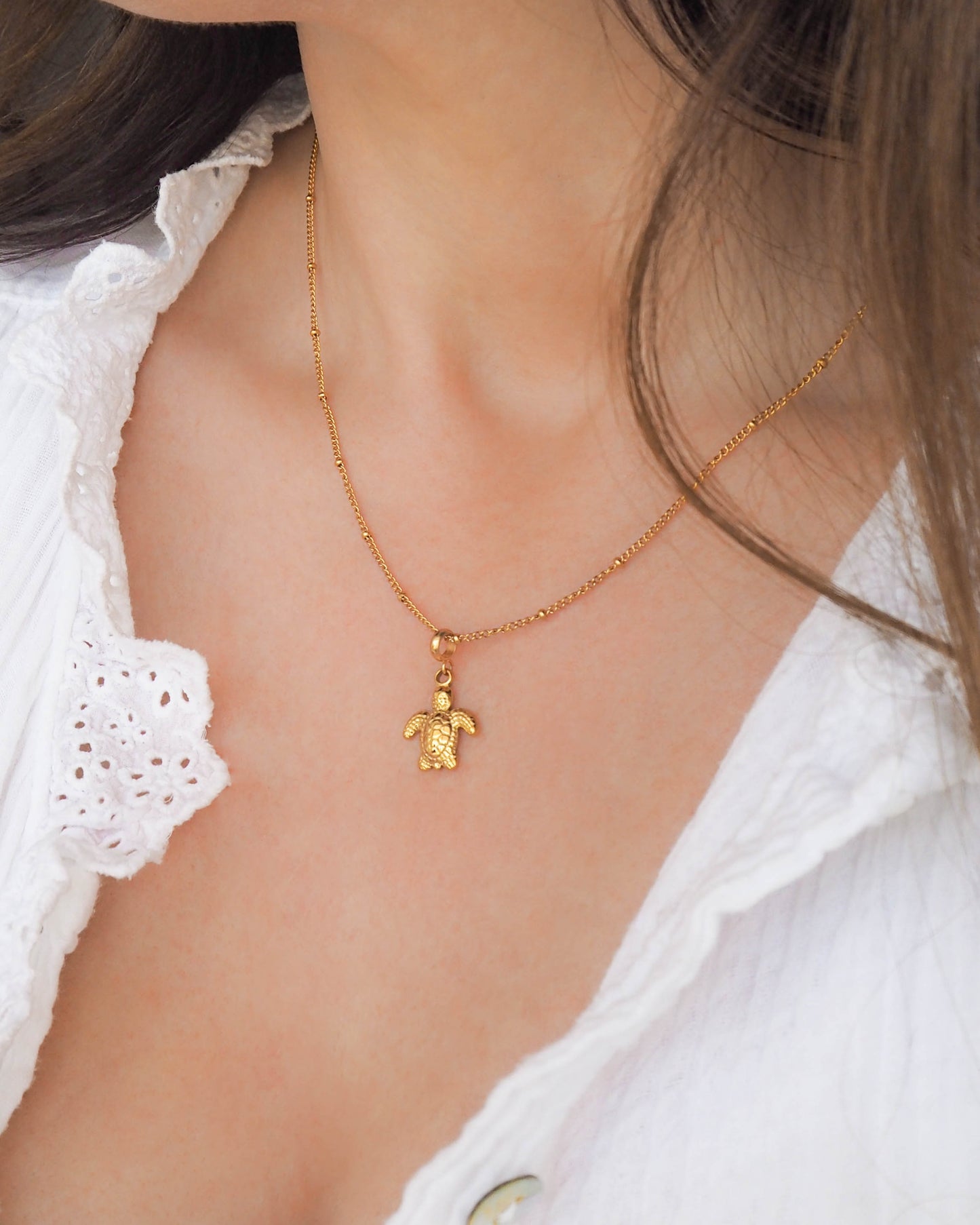 Model wearing Turtle Necklace made with Gold Stainless Steel