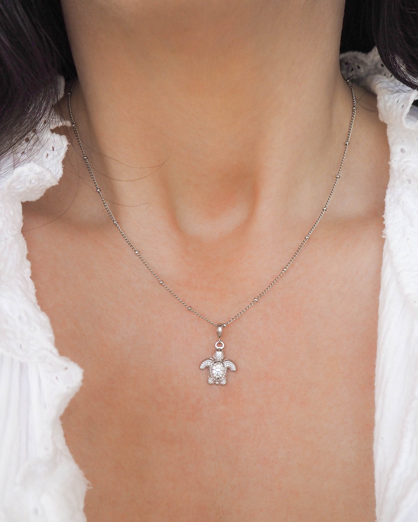 Model wearing Turtle Necklace made with Silver Stainless Steel