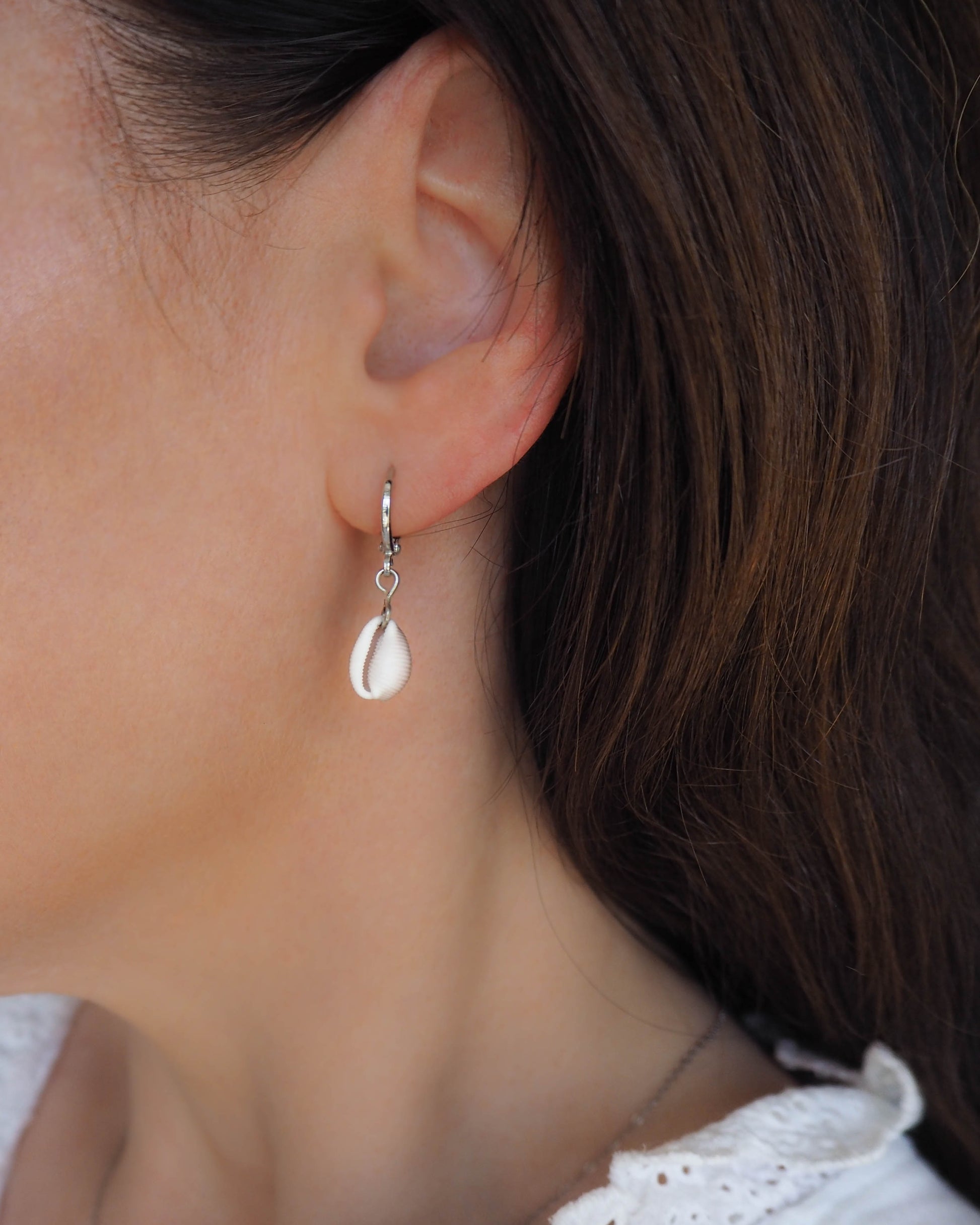 Model wearing Cowrie Shell earrings 925 silver, real shell earrings from Portugal, seashells from Algarve, Kauri