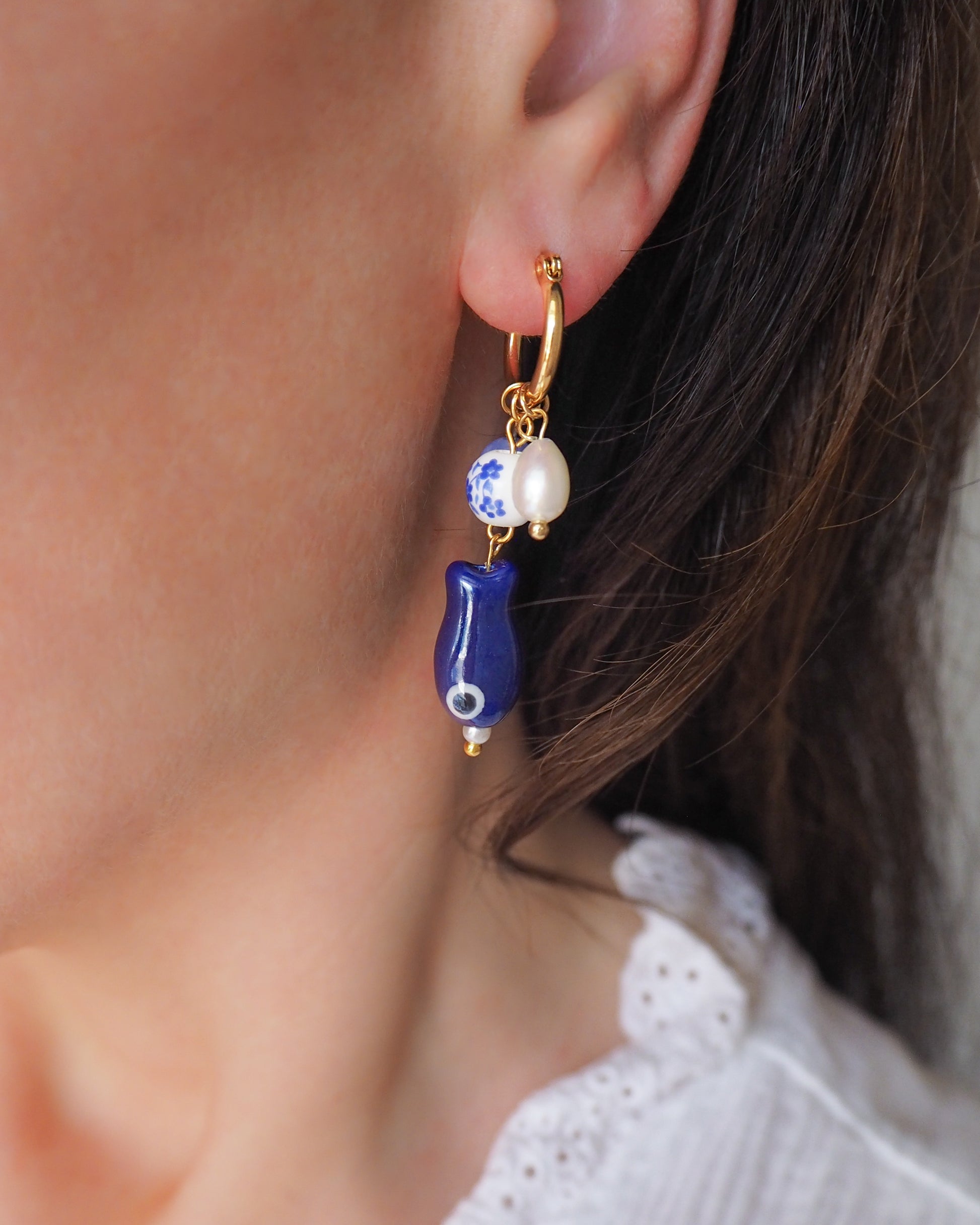 Model wearing Gold Portuguese Sardine Fish Azulejo Tile Earrings with Gemstones and Freshwater Pearls