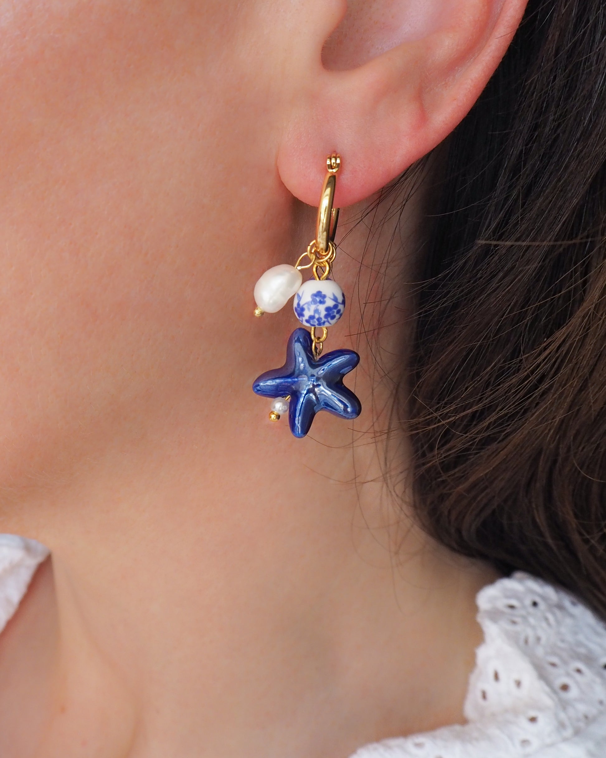 Model wearing Portuguese Blue Sea Star Starfish Gold Earrings with Azulejo Tile Beads, Freshwater Pearls and Gemstones - Handmade Ocean Inspired Jewelry