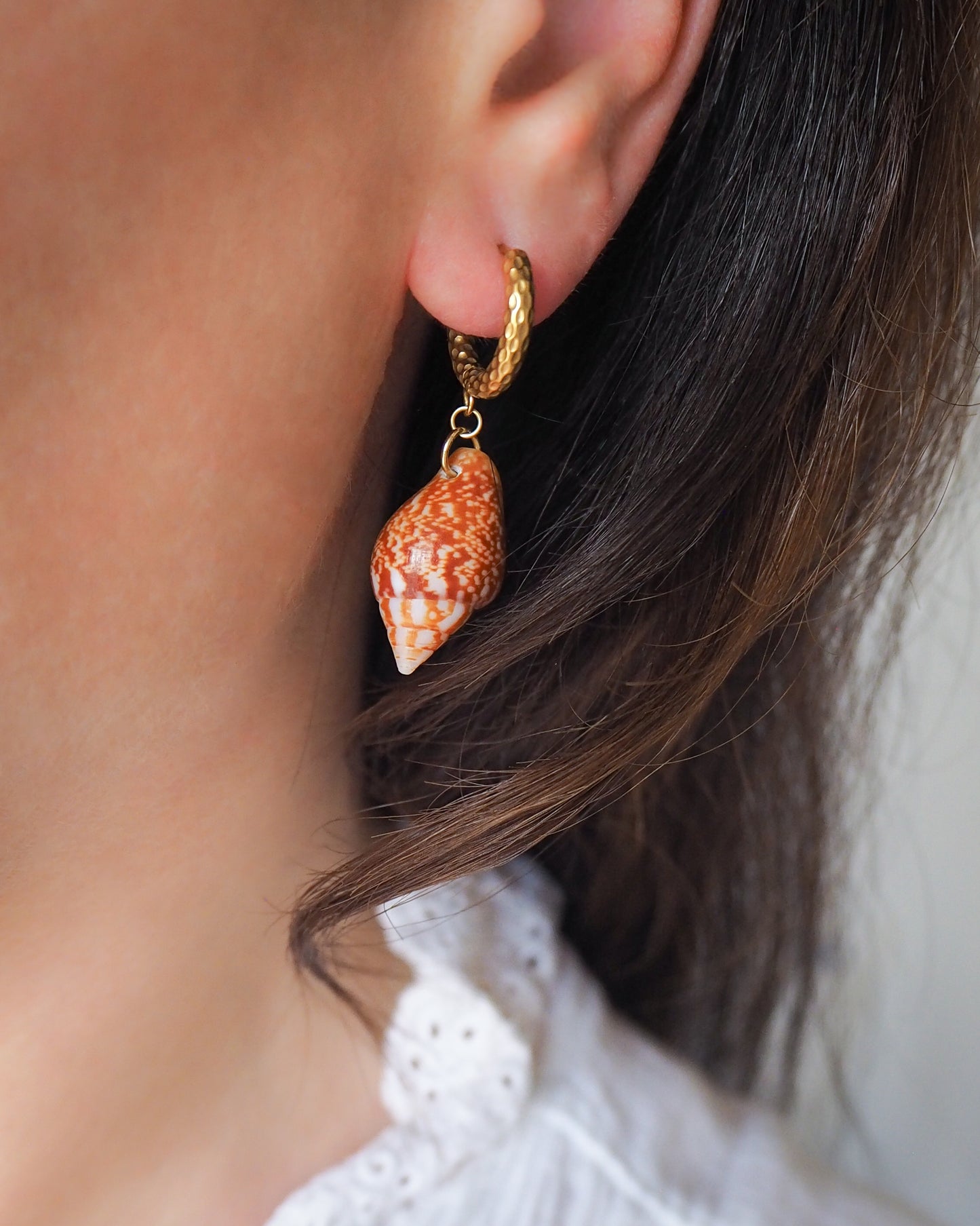 Model wearing Gold Rustic Dove Shell Earrings