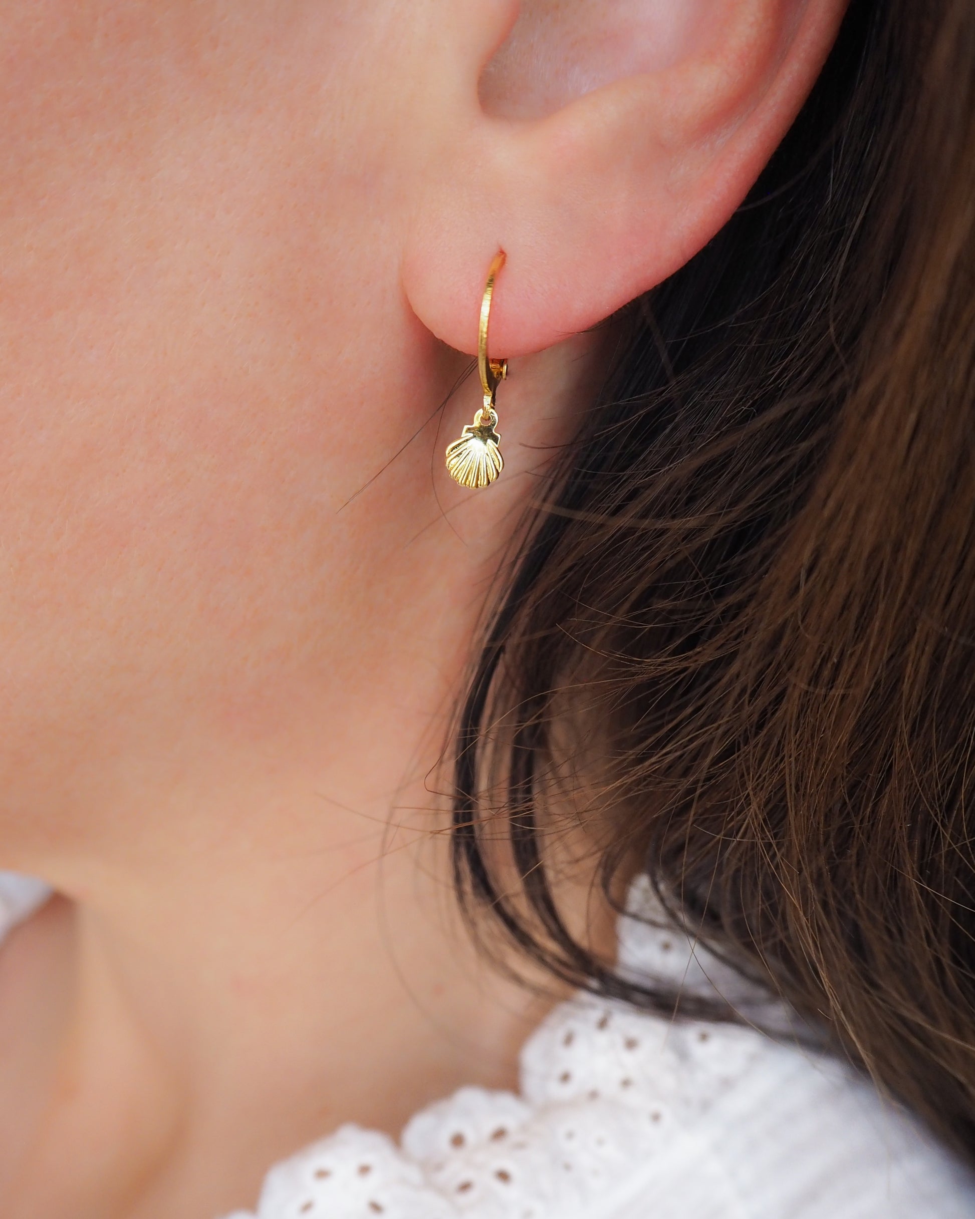 Gold Tiny Shell Earrings on model