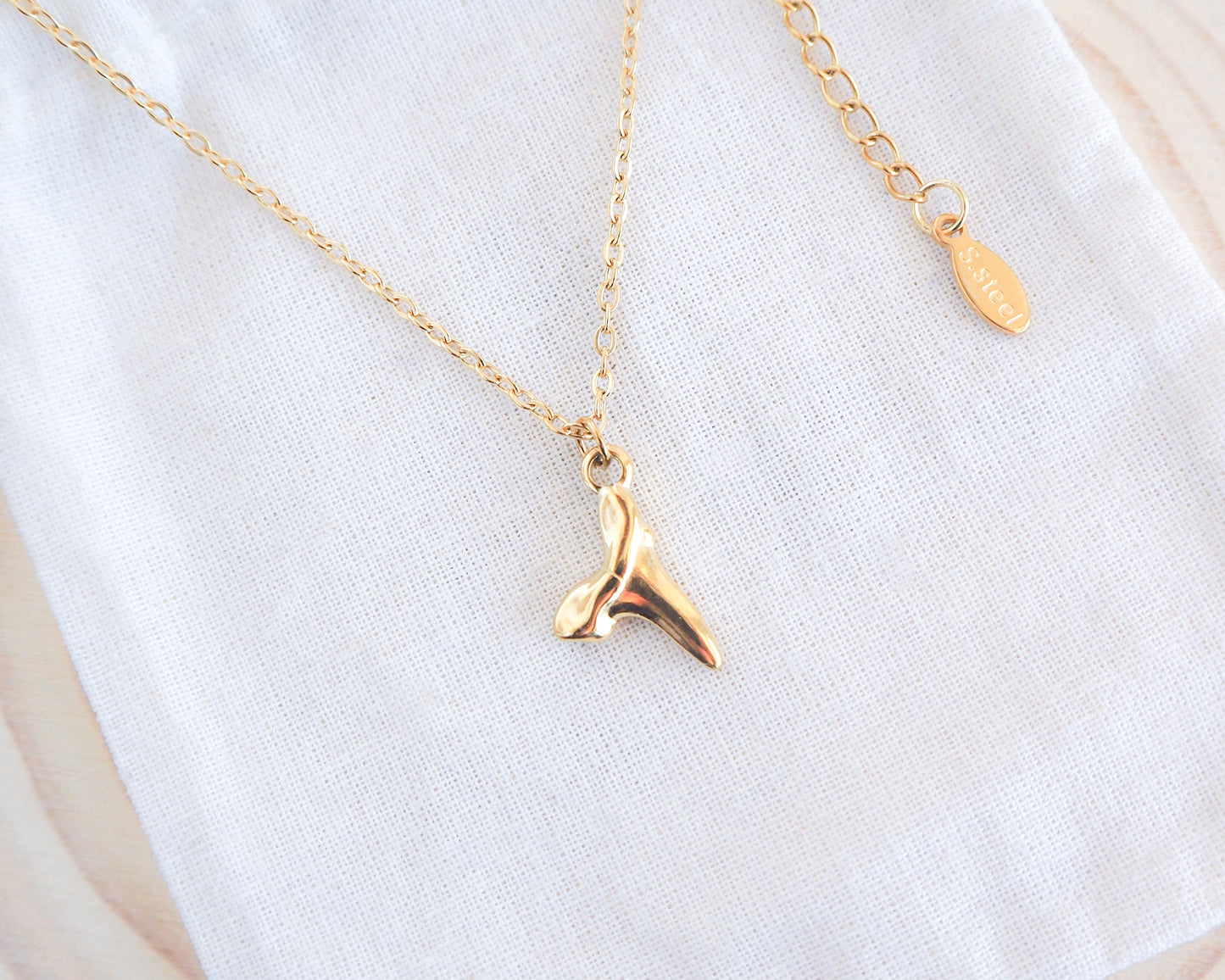 Gold Stainless Steel Necklace with Shark Tooth Pendant on display - Sea by Lou, Seabylou