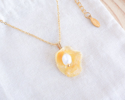 Yellow Jingle Shell Gold Necklace on display, Yellow Mother of Pearl Pendant