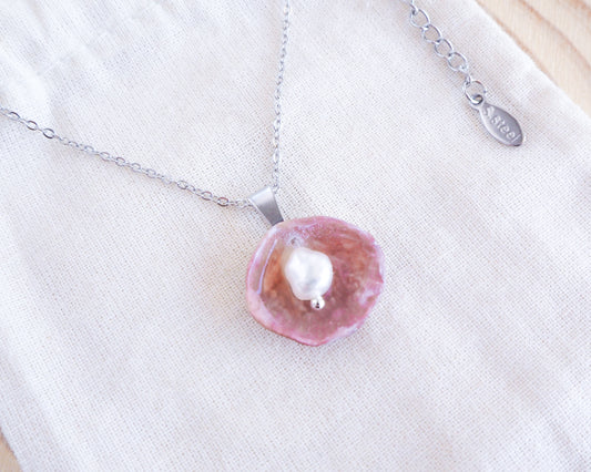 Fuchsia Jingle Shell Silver Necklace with freshwater pearl, Mother of Pearl Pendant on display