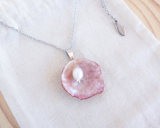 Pink Jingle Shell Silver Necklace with Freshwater Pearl on display