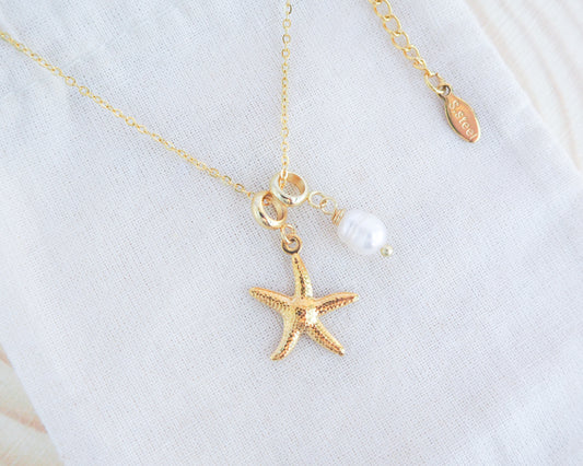 Gold Sea Star Starfish Necklace with Freshwater Pearl Bead on display