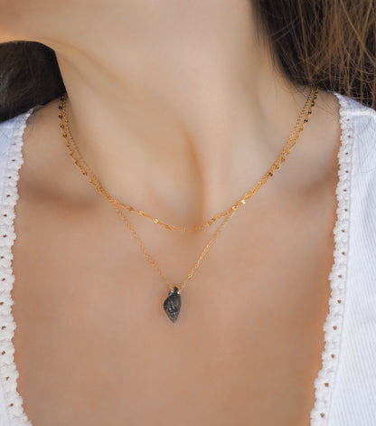 Tiny Dark Shell Necklace, Gold Plated Chain, Netted Dogwhelk Shell from Portugal on model