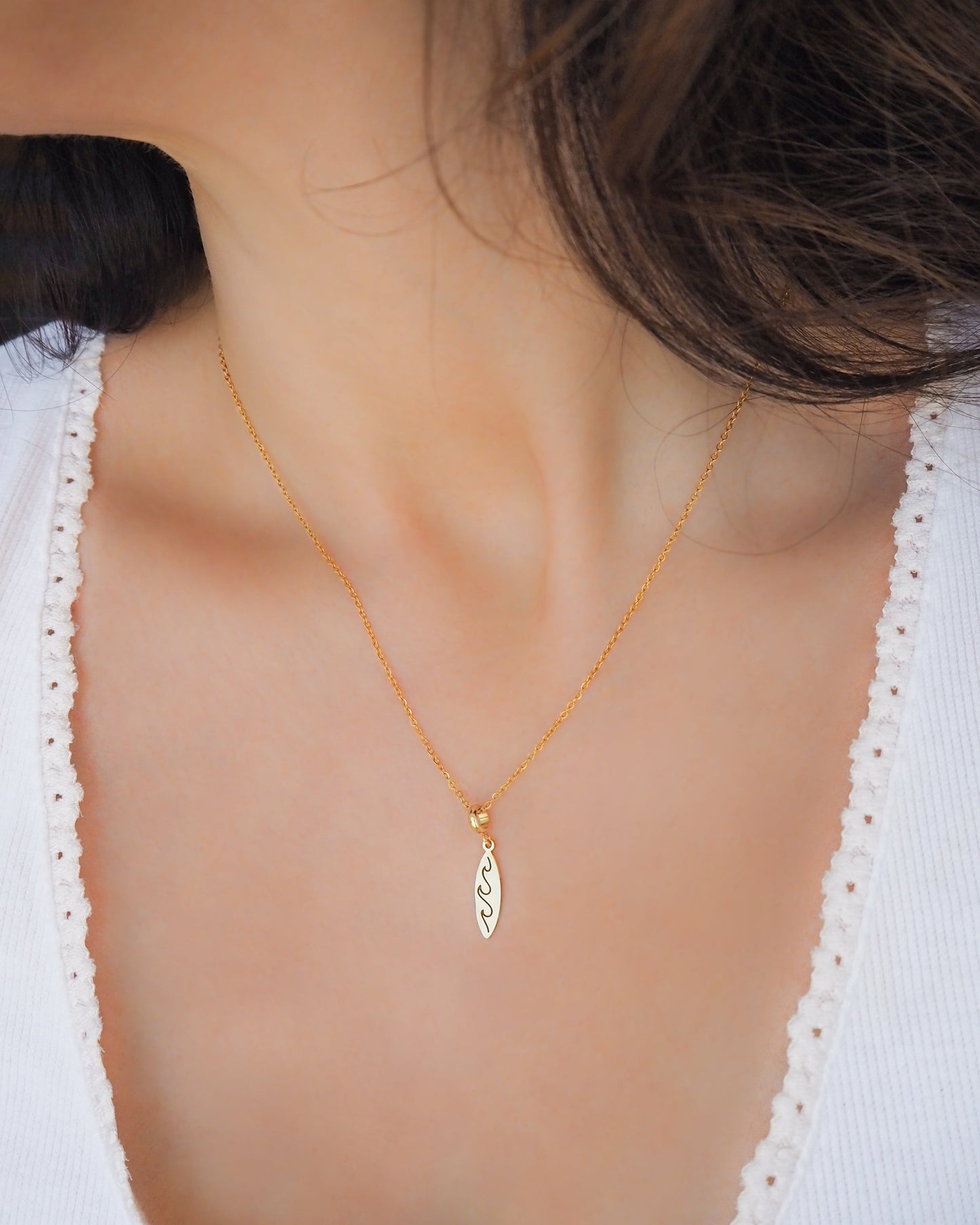 Gold Surfboard Necklace, Surf Girl Wave necklace, Waterproof beach jewelry on model