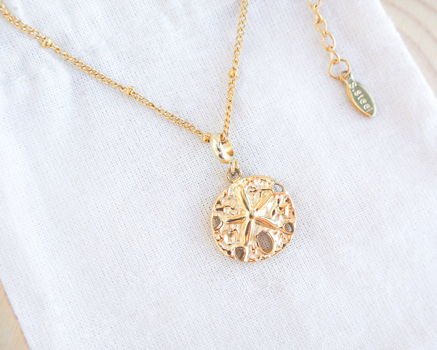 Sand Dollar Necklace Gold Chain on display