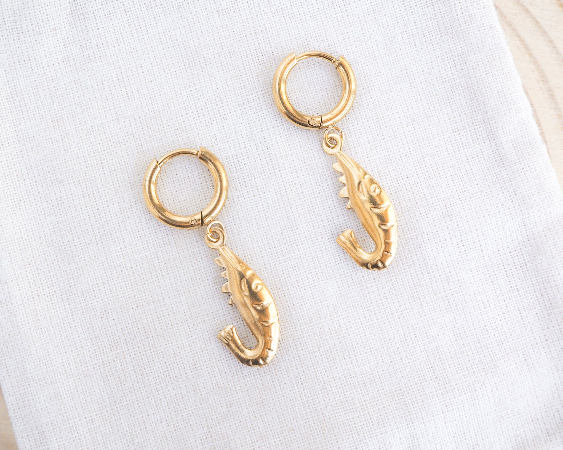 Gold Shrimp Earrings, Shrimp Huggies on display