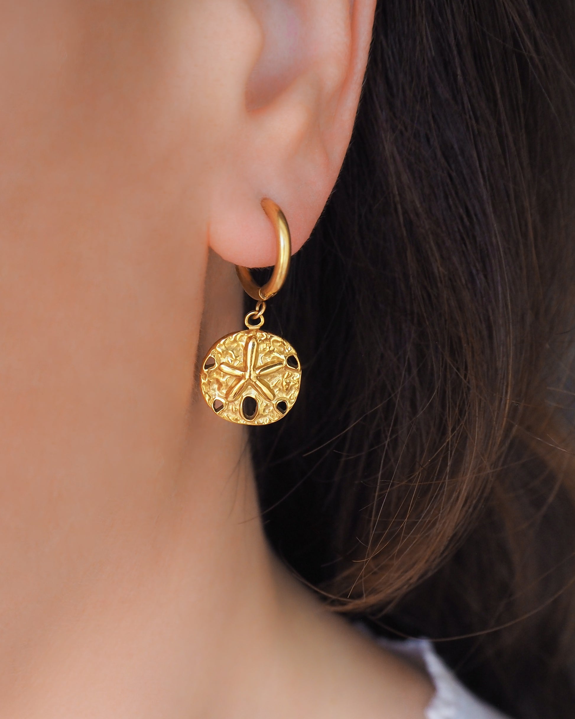 Gold Sand Dollar Hoop Earrings in ear model