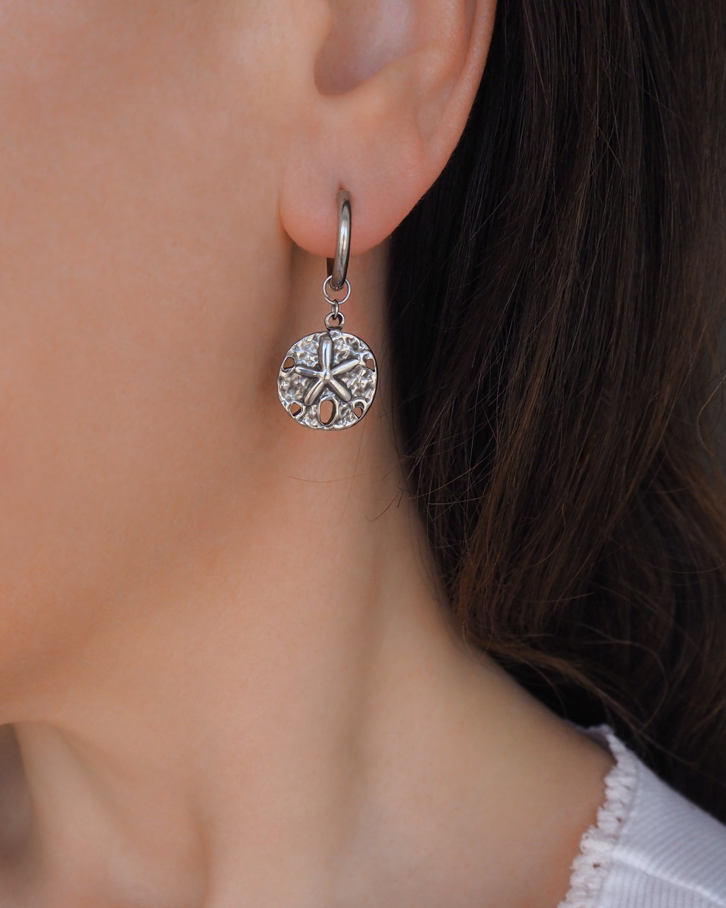 Silver Sand Dollar Hoop Earrings in ear model