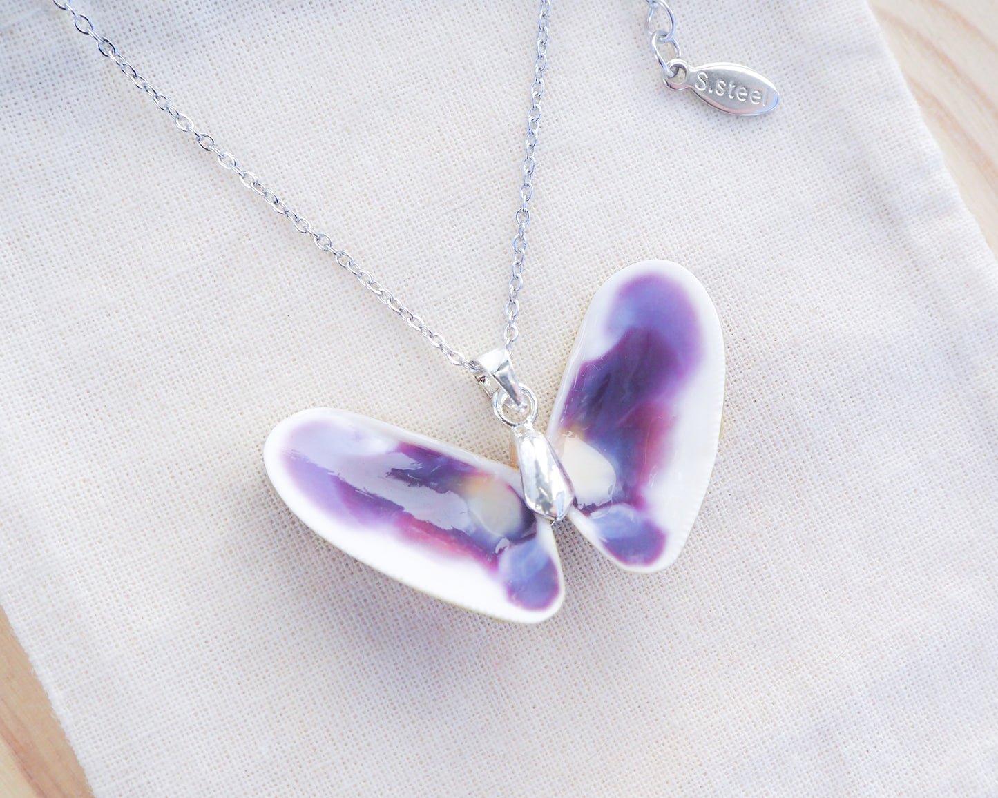 Purple Coquina Shell Butterfly Silver Necklace V on display