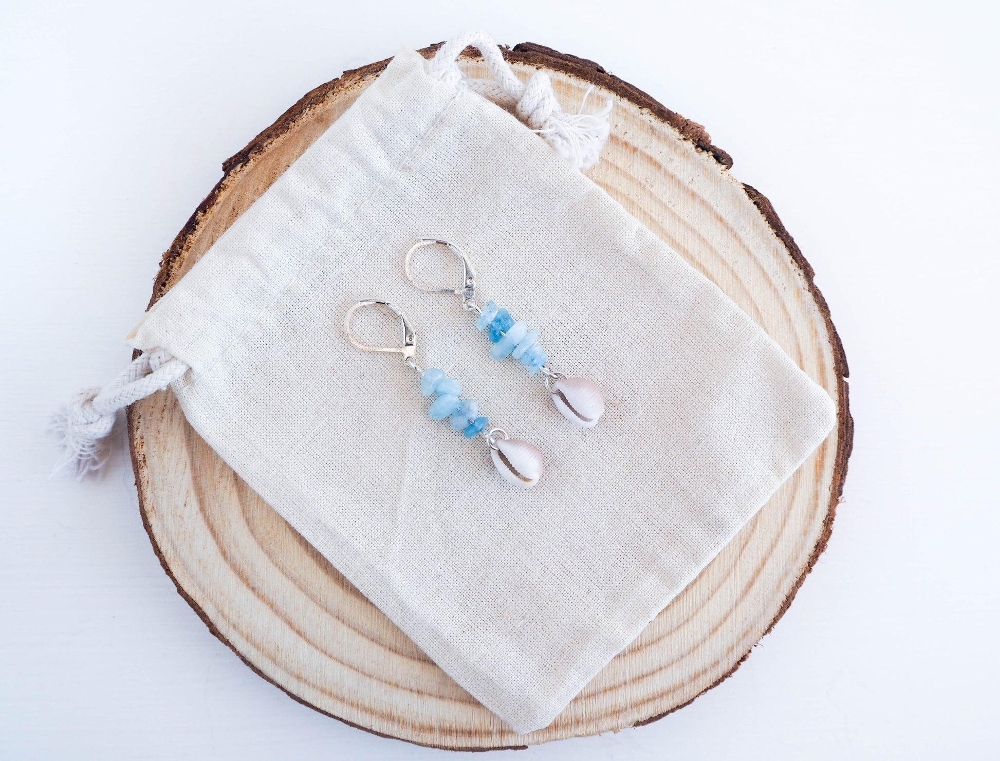Elegant Cowrie Shell Earrings from Portugal with Shimmering Aquamarine Accents